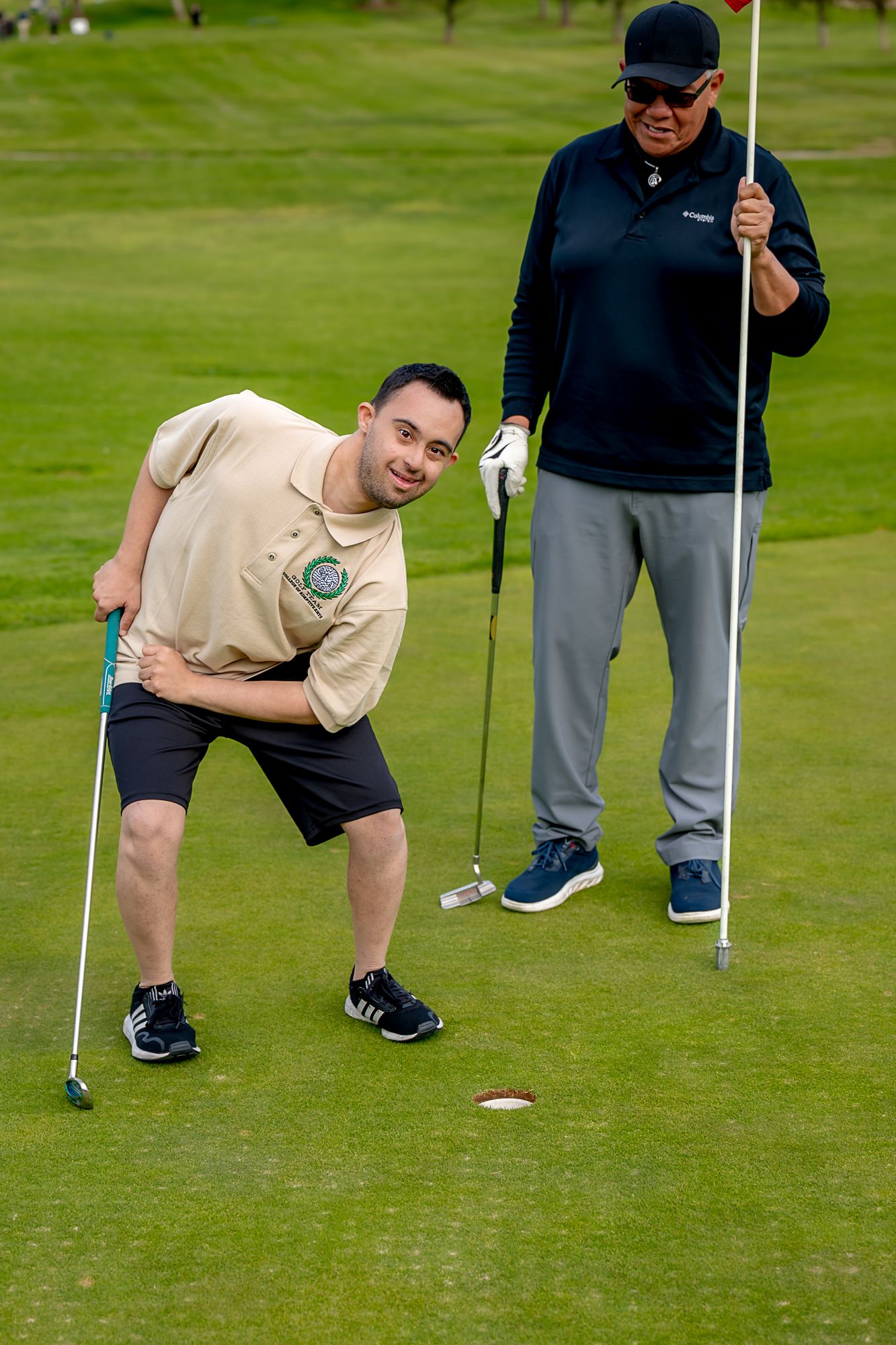 A CAA student practicing golf with an instructor
