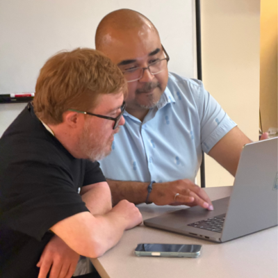 Student working with instructor on computer