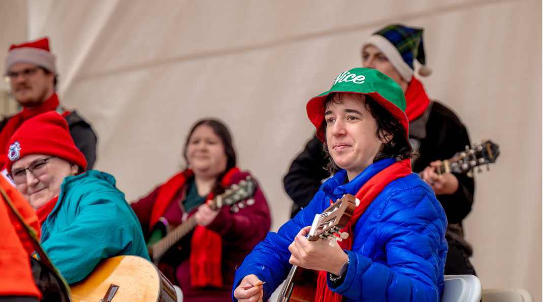 Students playing the guitar on stage